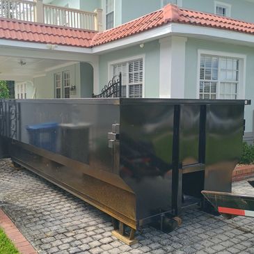 20 Yard Roll Off Dumpster Rental - Delivered under the carport with no damage to driveway or pavers.
