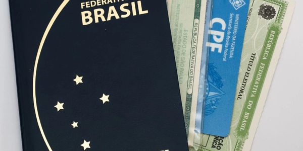 Brazilian passport and identification documents on a white surface.