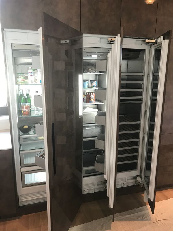 Open double-door refrigerator and freezer with some food items inside.