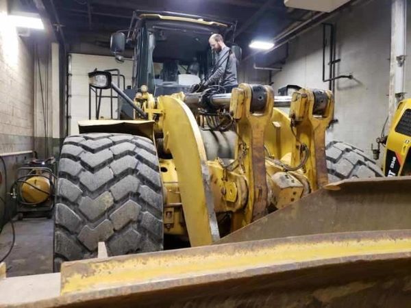 yellow excavator in a garage