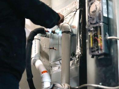 alt="Technician repairing heat pump for residential furnace in GTA"