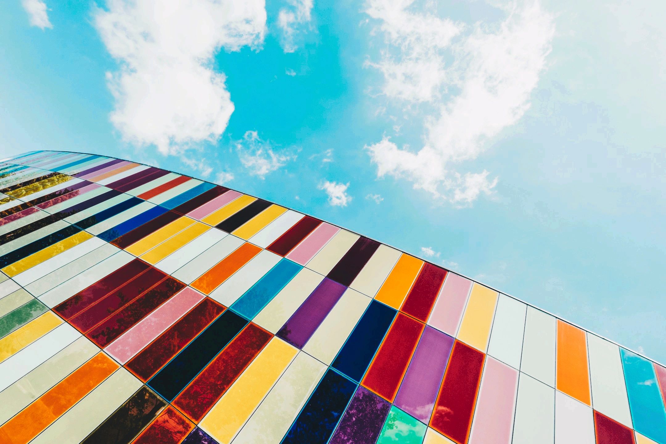 Colorful tiled building facade under a bright sky.