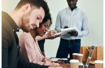 A group of three people at a meeting to illustrate diversity and inclusion