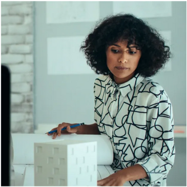 Photo of a woman looking at a building model