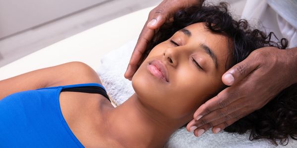 Woman receiving a relaxing head massage.