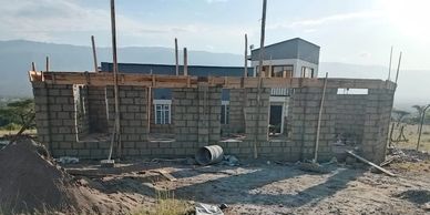 A partially built brick house under clear skies.