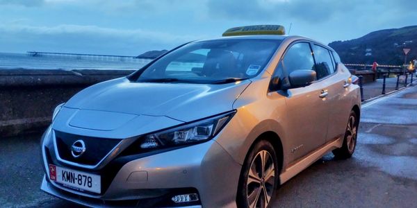 Nissan Leaf fully electric taxi on Ramsey Promenade on the Isle of Man