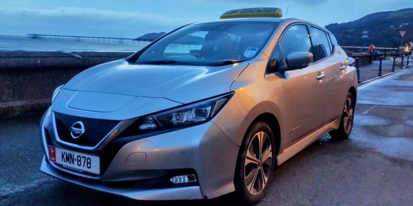 Nissan Leaf fully electric taxi on Ramsey Promenade on the Isle of Man