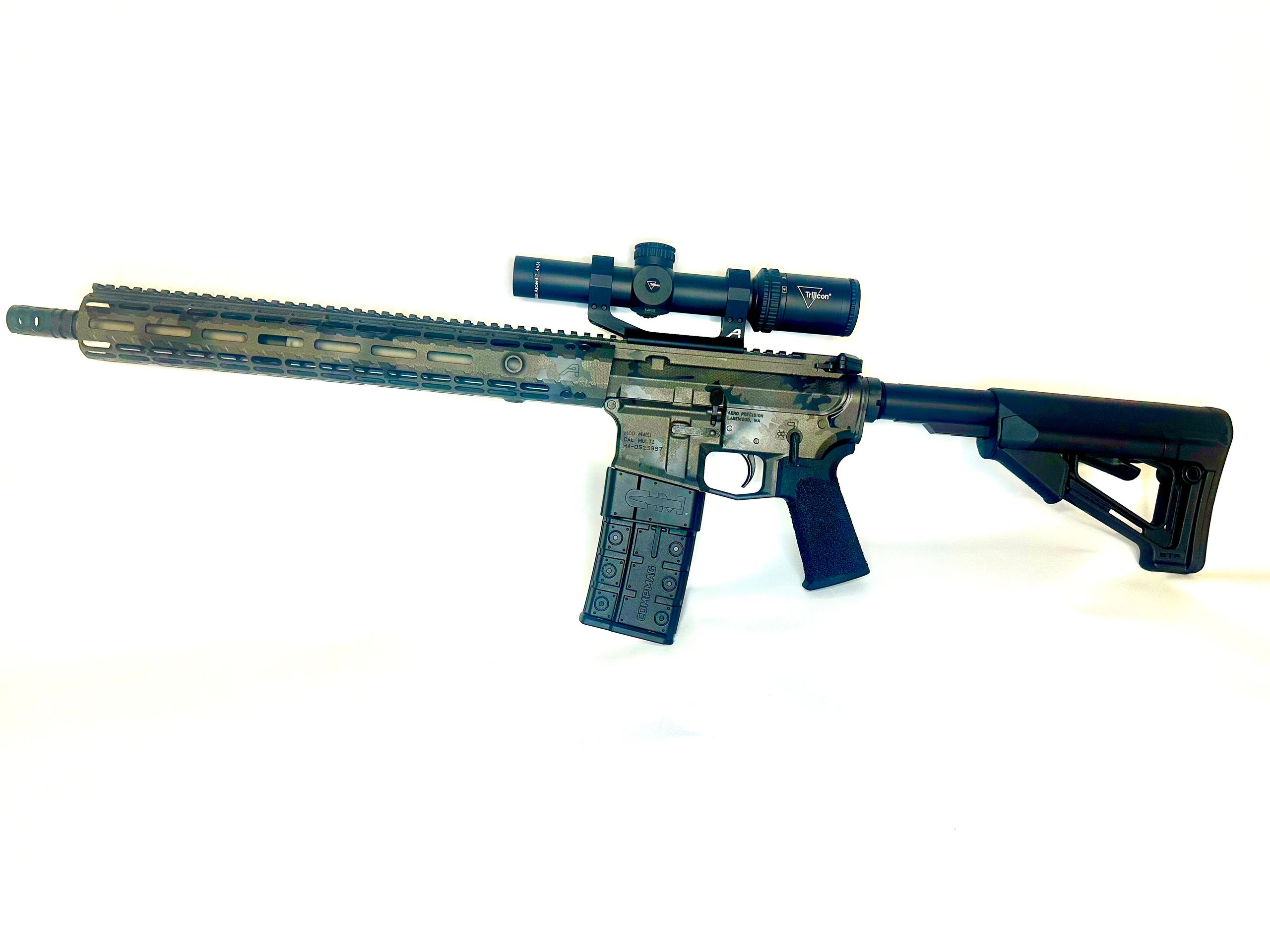 A camouflaged AR-style rifle with a scope and black stock.