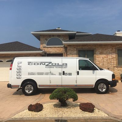 ConZolaFloors.Biz van in front of customer's home