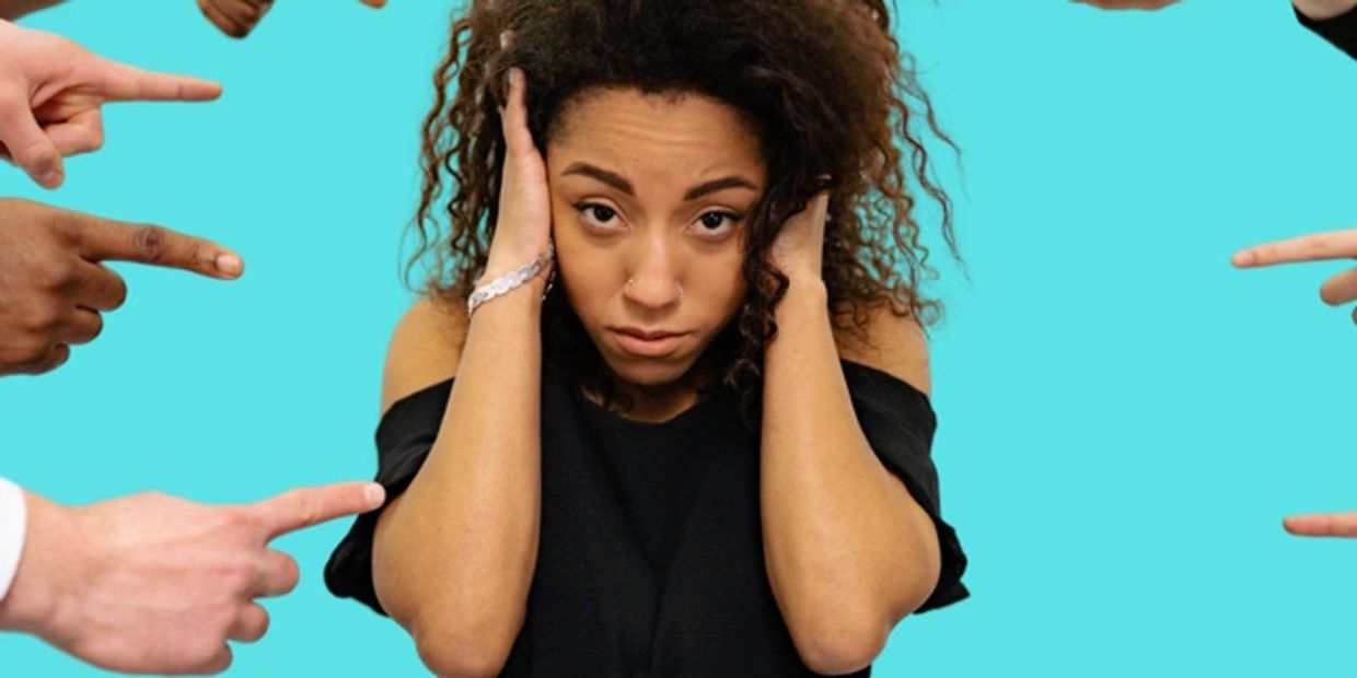Woman with hands in head feeling the demands of worry, stress, and isolation associated with anxiety
