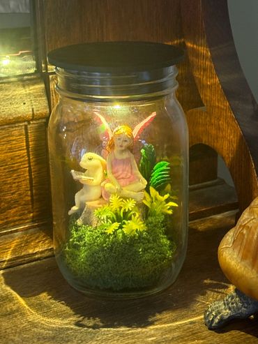 A fairy garden inside a mason jar.