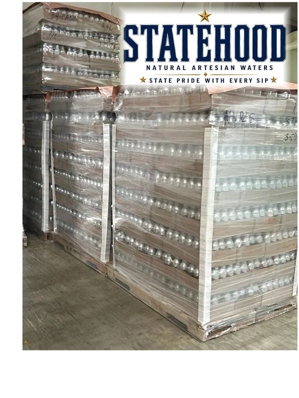 Large pallets of Statehood bottled water stacked and wrapped.