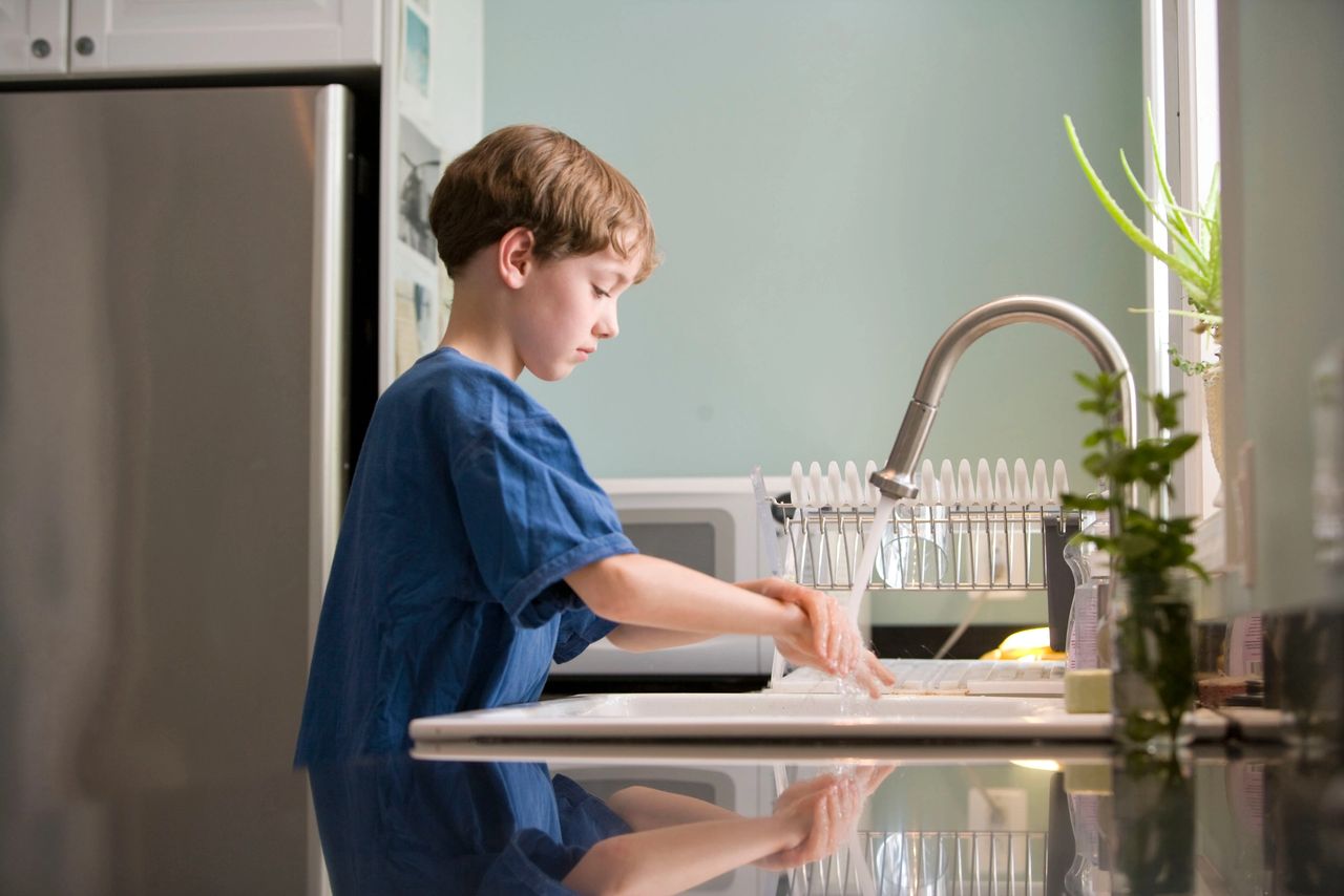 boy washing his hands