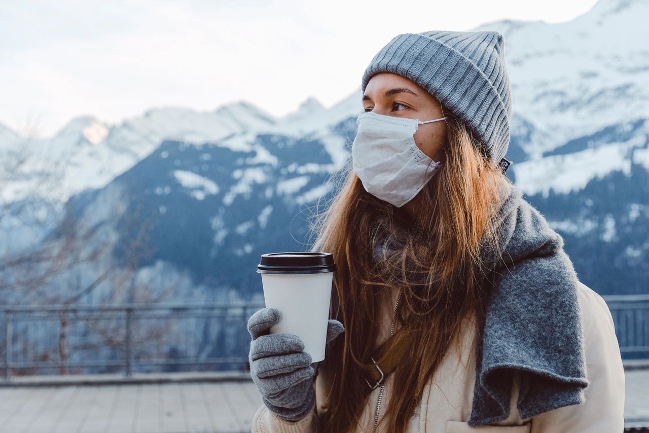 woman in beanie wearing a mask