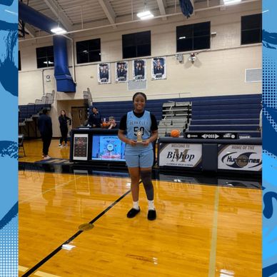 Young basketball player holding a trophy on the court.