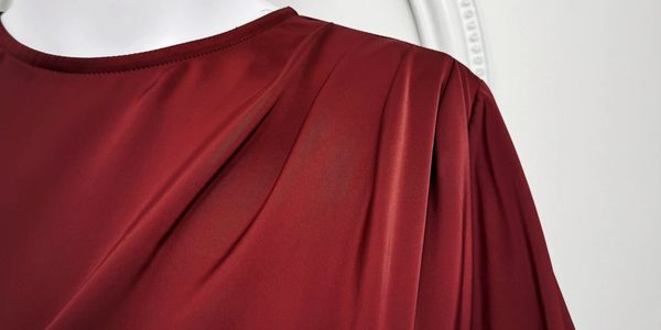 red pleaded neckline abaya from Al Hilal