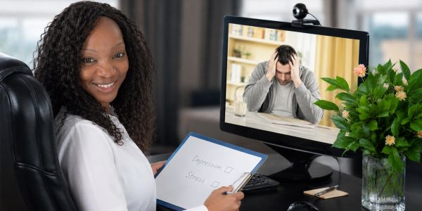 Therapist conducting an online counseling session.