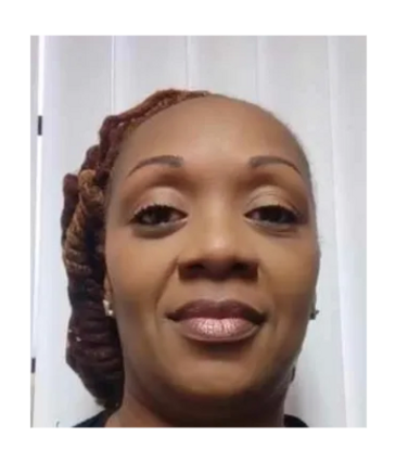 Close-up portrait of a woman with styled hair and neutral makeup.