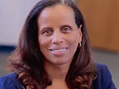 Professional woman with long hair smiling warmly.