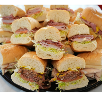 A platter of assorted deli sandwiches.