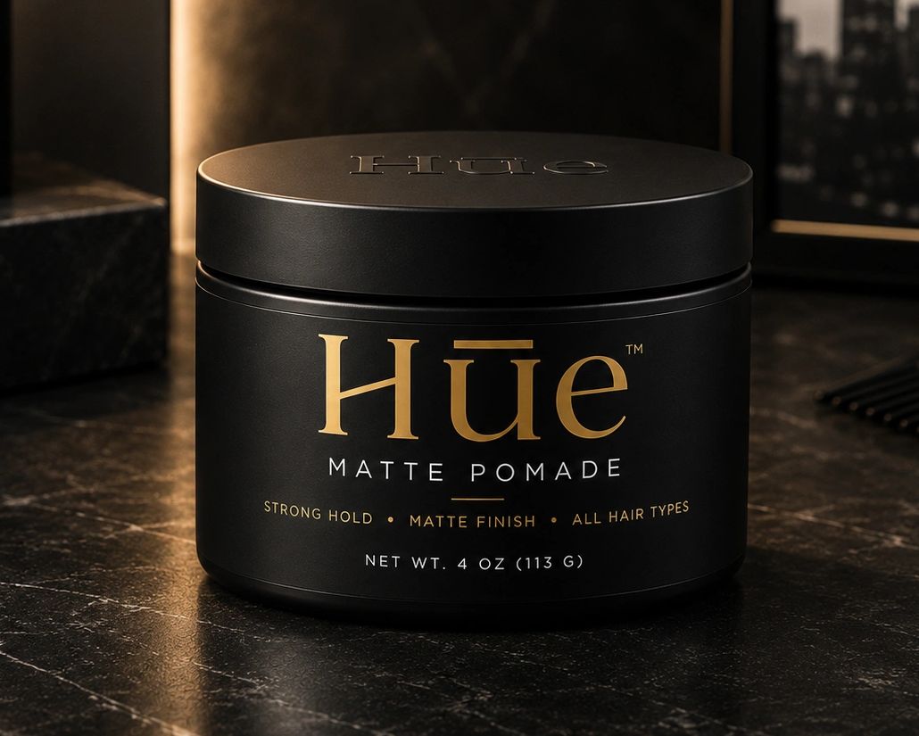 Hue matte pomade container on a dark surface.
