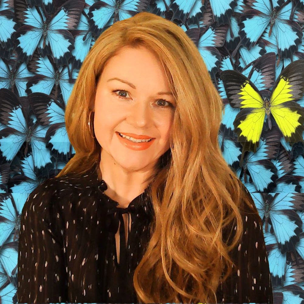 Image of Carole Jean smiling against a black and bright blue butterfly background.