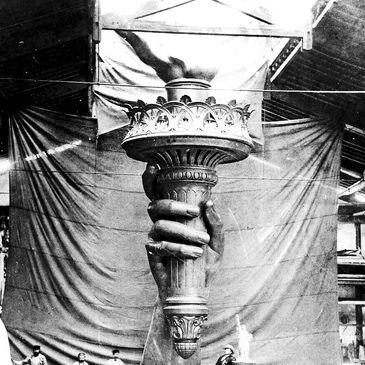 An old photograph of the torch of the Statue of Liberty during construction.