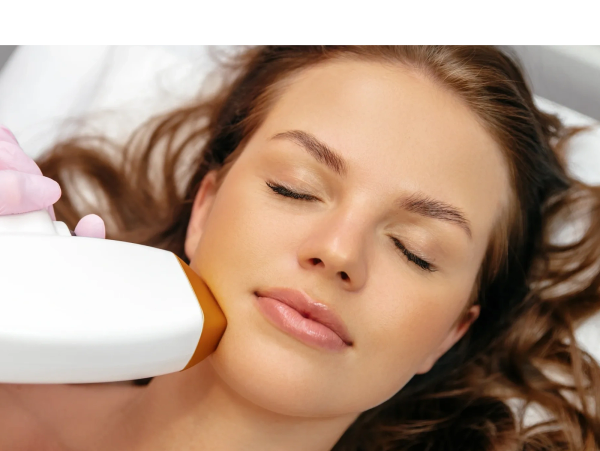 Woman receiving a laser skin treatment on her face.