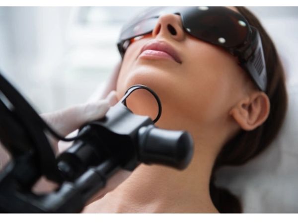Woman undergoing a laser treatment on her neck.