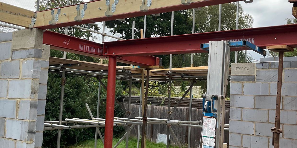 Construction site with steel beams and scaffolding.