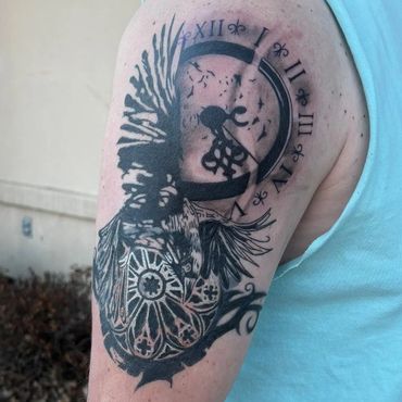 Intricate tattoo of a Native American chief with a clock on upper arm.