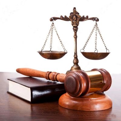 A Balance on a Wooden Table With a Mallet Image in Color