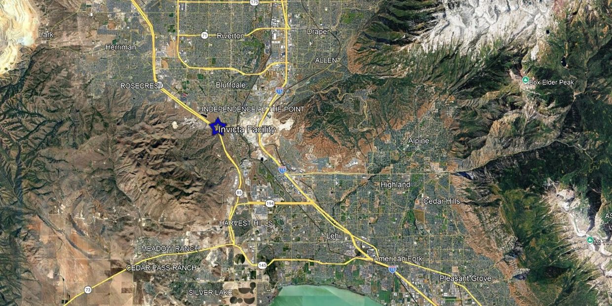 Satellite view of a mountainous urban area with labeled places and roads.