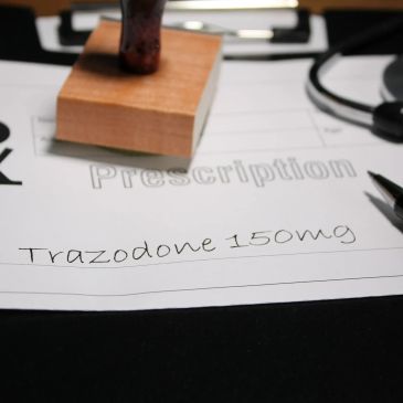 Prescription paper with Trazodone 150mg written on it.