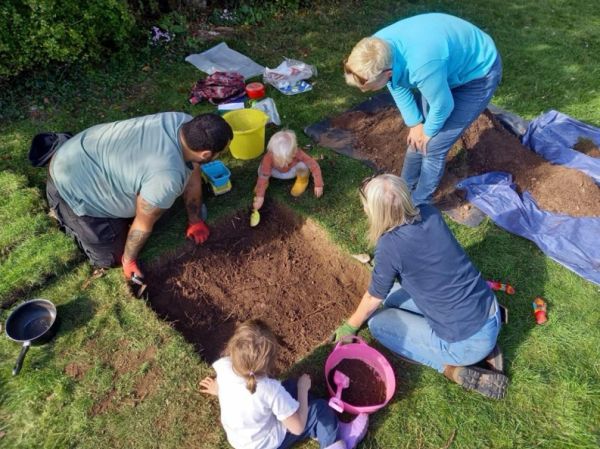 Family gardening together outdoors.