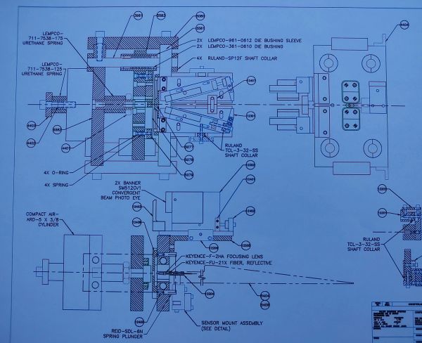 Engineering blueprint of a mechanical assembly with labeled parts.