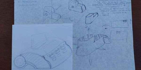 Sketches and technical drawings of a mechanical device on paper.