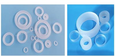 Various sizes of white plastic rings on a blue surface.