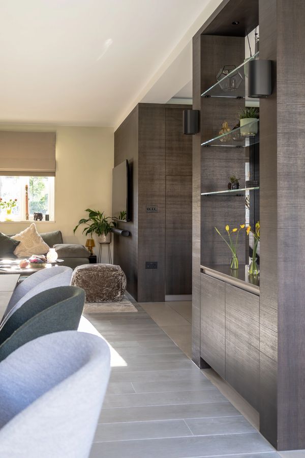 Modern living room with gray furniture and dark wood accents.