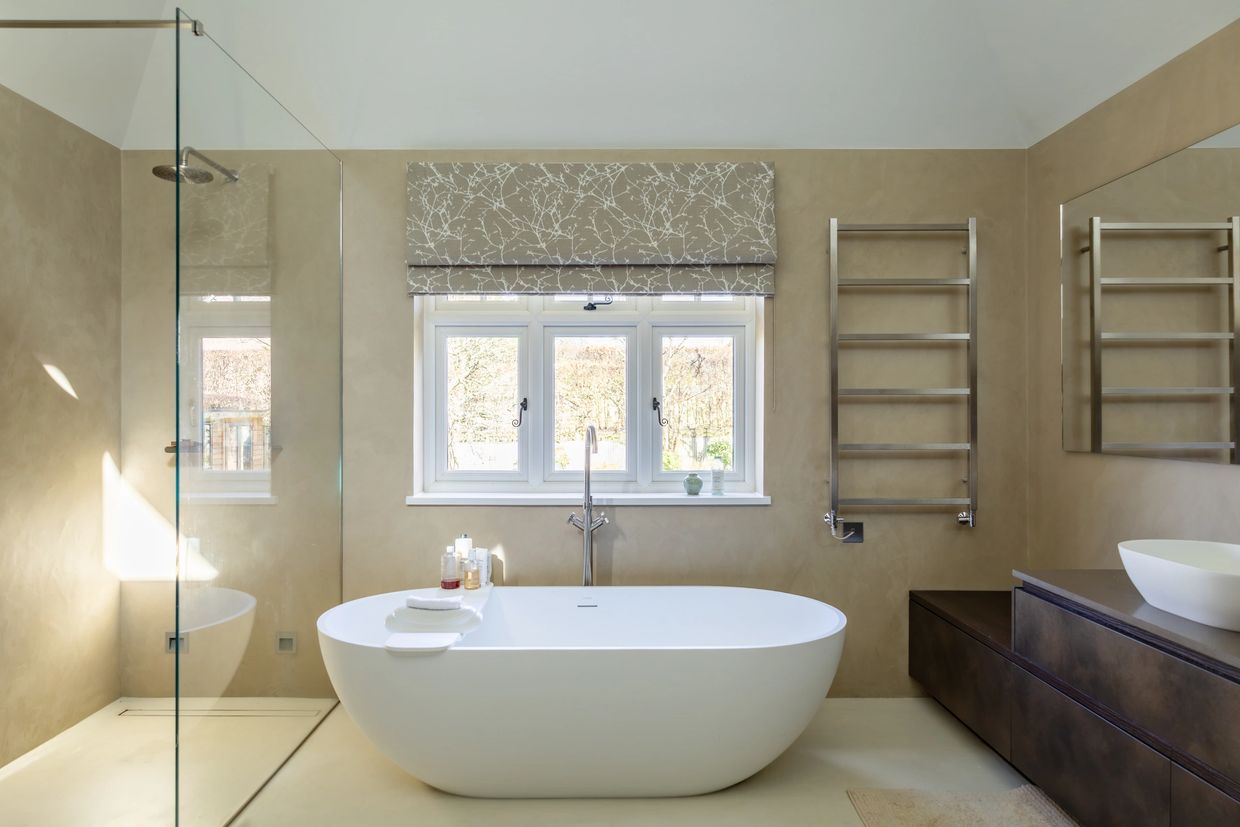 Modern bathroom with a freestanding bathtub and glass shower.