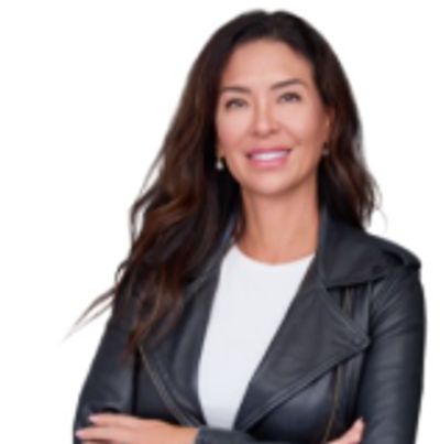 Confident woman in a black leather jacket smiling.