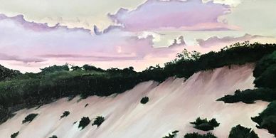 A landscape with sandy hills and a pastel-colored sky.