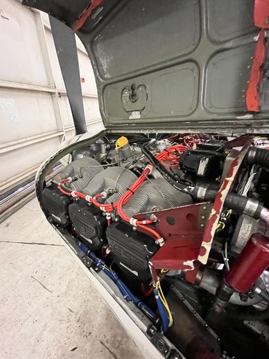 Close-up of an aircraft engine inside the engine compartment.