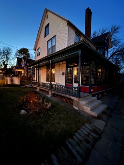 Front 3/4 view of artist residency, victorian home, front porch