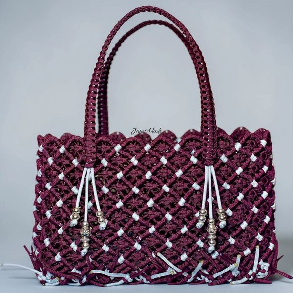 Handwoven maroon and white basket bag with beads.