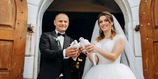 people holding doves at their wedding.