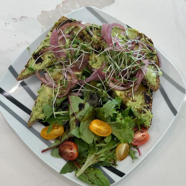 Avocado Toast topped with Pickled Onions, Balsamic Glaze, and Microgreens served with a Side Salad w