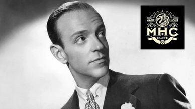Classic black-and-white portrait of a man in a suit with MHC logo.