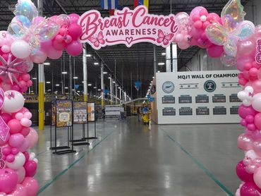 Pink for Purpose Indiana Fever banner with pink ribbon balloon columns